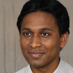 Joyful black young-adult male with short  black hair and brown eyes