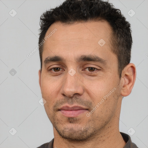 Joyful white adult male with short  black hair and brown eyes