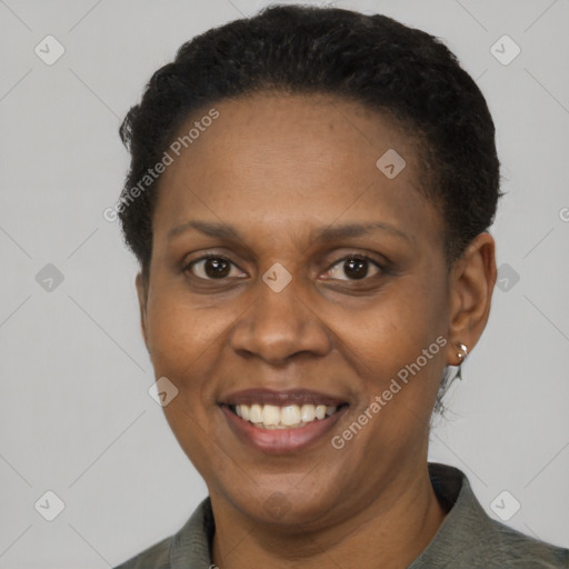 Joyful black adult female with short  brown hair and brown eyes