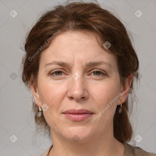 Joyful white adult female with medium  brown hair and grey eyes