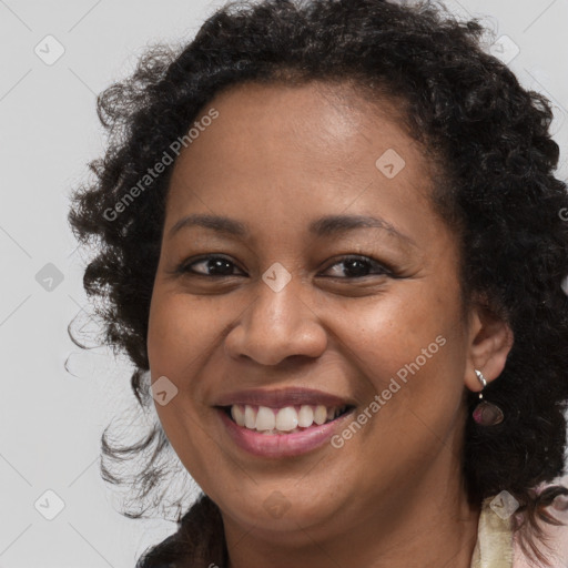 Joyful black young-adult female with long  brown hair and brown eyes