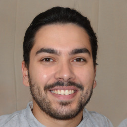 Joyful white young-adult male with short  black hair and brown eyes