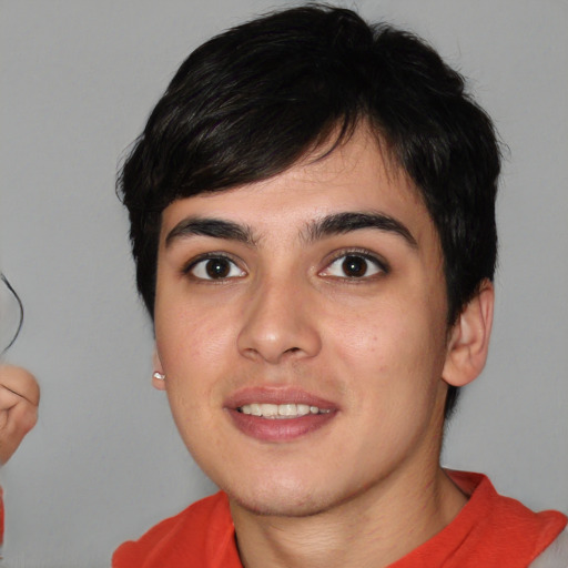 Joyful white young-adult male with short  black hair and brown eyes