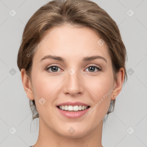 Joyful white young-adult female with medium  brown hair and grey eyes