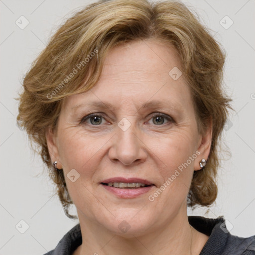 Joyful white adult female with medium  brown hair and blue eyes