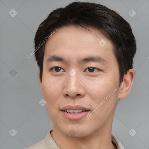 Joyful asian young-adult male with short  brown hair and brown eyes