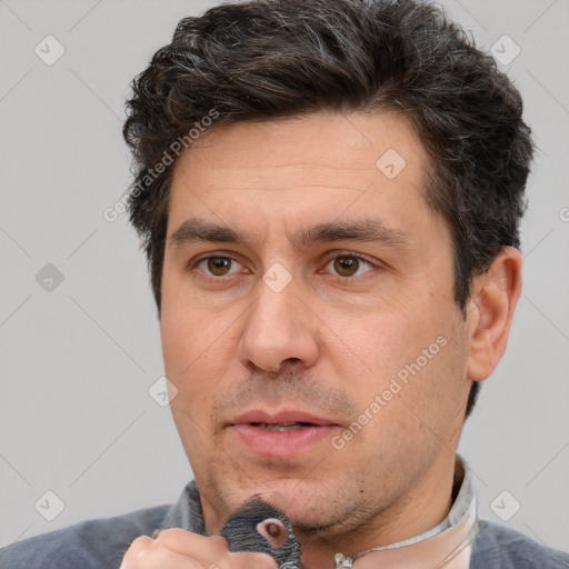 Joyful white adult male with short  brown hair and brown eyes