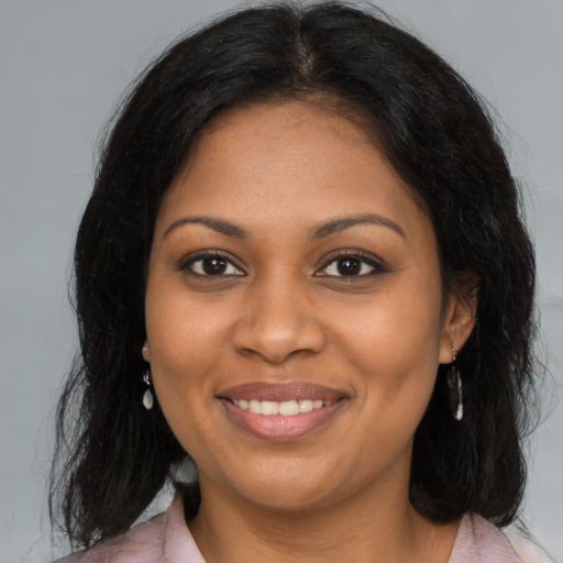 Joyful black young-adult female with medium  brown hair and brown eyes