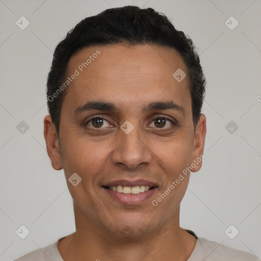Joyful latino young-adult male with short  black hair and brown eyes