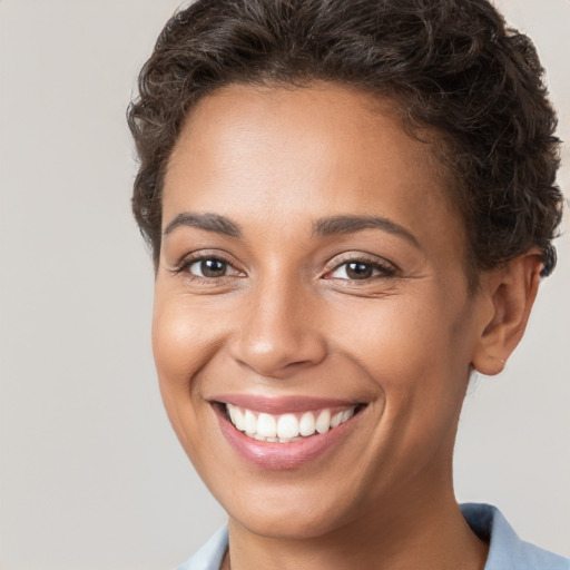 Joyful white young-adult female with short  brown hair and brown eyes