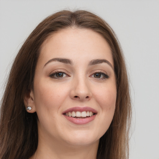 Joyful white young-adult female with long  brown hair and grey eyes