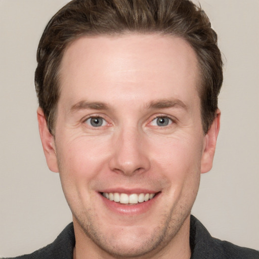 Joyful white adult male with short  brown hair and grey eyes