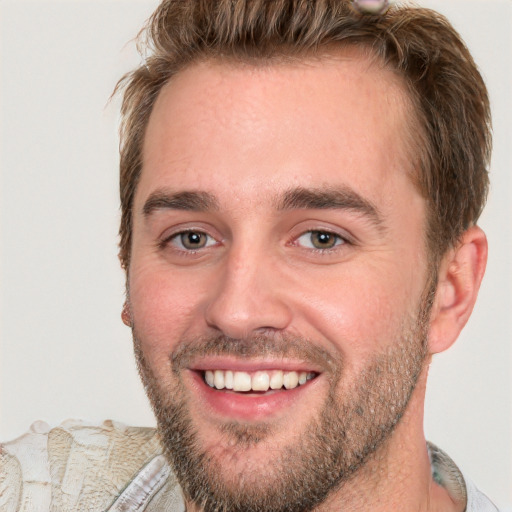 Joyful white young-adult male with short  brown hair and grey eyes