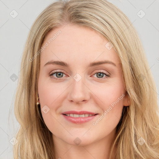 Joyful white young-adult female with long  brown hair and green eyes