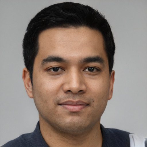 Joyful asian young-adult male with short  black hair and brown eyes