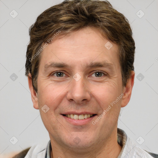 Joyful white adult male with short  brown hair and grey eyes