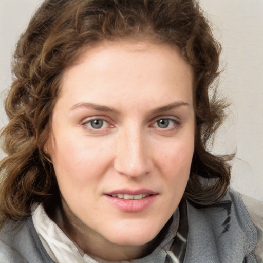 Joyful white young-adult female with medium  brown hair and blue eyes