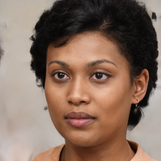 Joyful black young-adult female with medium  black hair and brown eyes