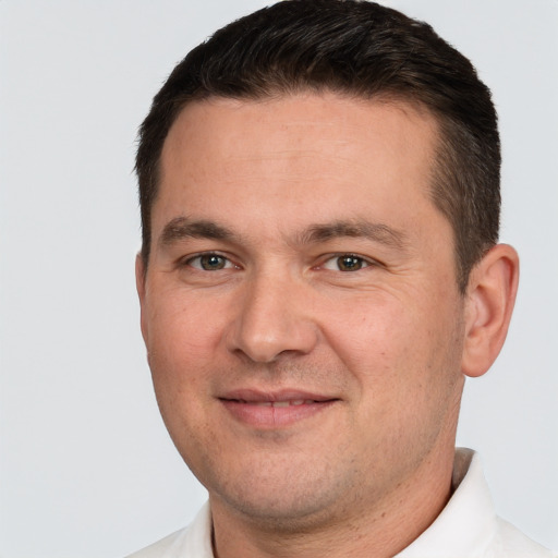 Joyful white adult male with short  brown hair and brown eyes