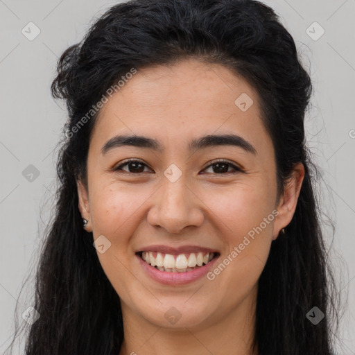 Joyful latino young-adult female with long  brown hair and brown eyes