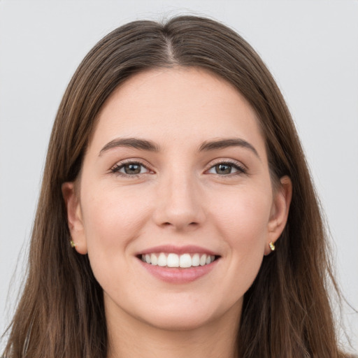 Joyful white young-adult female with long  brown hair and grey eyes