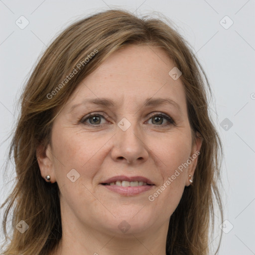 Joyful white adult female with long  brown hair and grey eyes