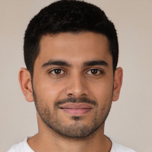 Joyful latino young-adult male with short  brown hair and brown eyes