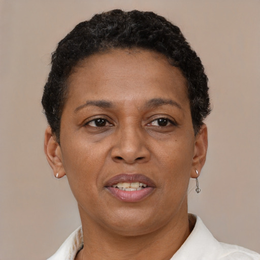 Joyful latino adult female with short  brown hair and brown eyes