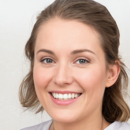 Joyful white young-adult female with medium  brown hair and blue eyes