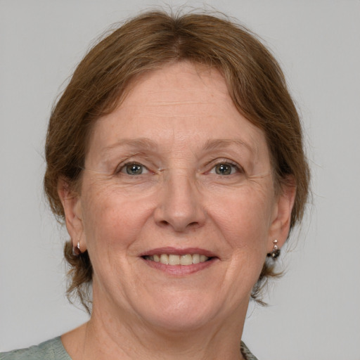 Joyful white middle-aged female with medium  brown hair and grey eyes