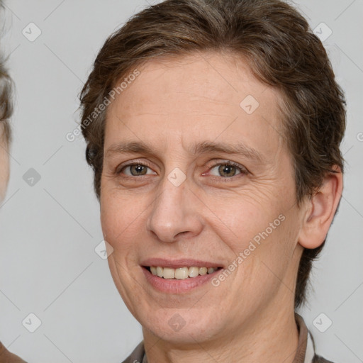 Joyful white adult female with short  brown hair and brown eyes