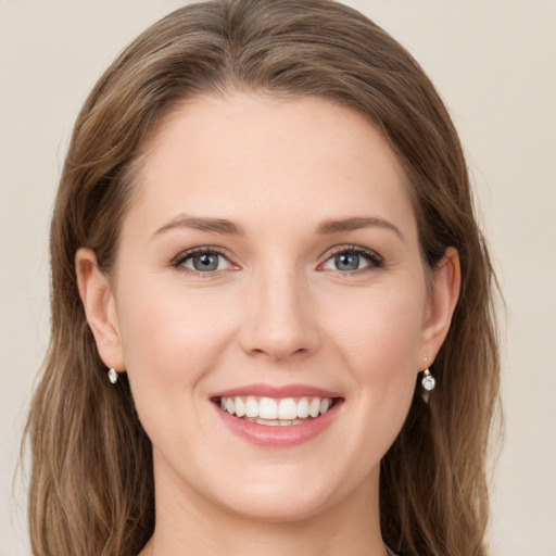 Joyful white young-adult female with long  brown hair and grey eyes