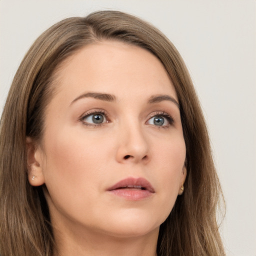 Neutral white young-adult female with long  brown hair and green eyes