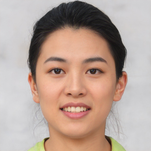 Joyful asian young-adult female with short  black hair and brown eyes