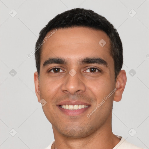 Joyful latino young-adult male with short  black hair and brown eyes