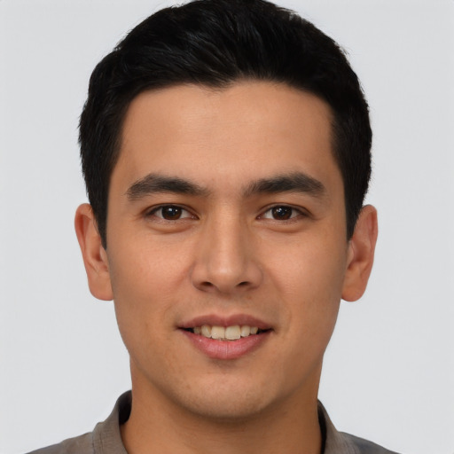 Joyful asian young-adult male with short  black hair and brown eyes