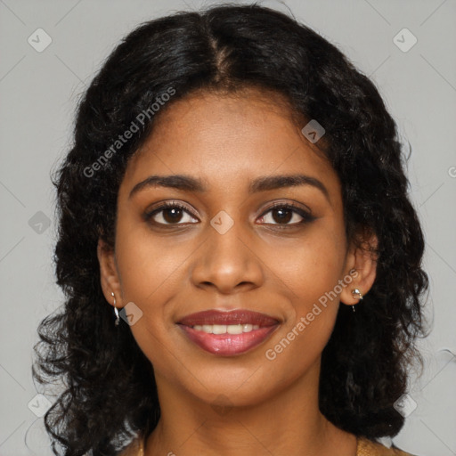 Joyful black young-adult female with long  black hair and brown eyes