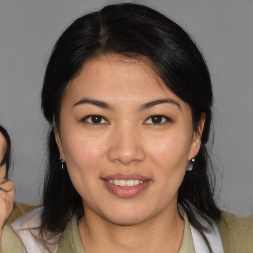 Joyful asian young-adult female with medium  brown hair and brown eyes