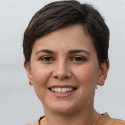 Joyful white young-adult female with short  brown hair and grey eyes