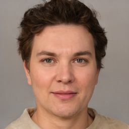 Joyful white adult male with short  brown hair and grey eyes