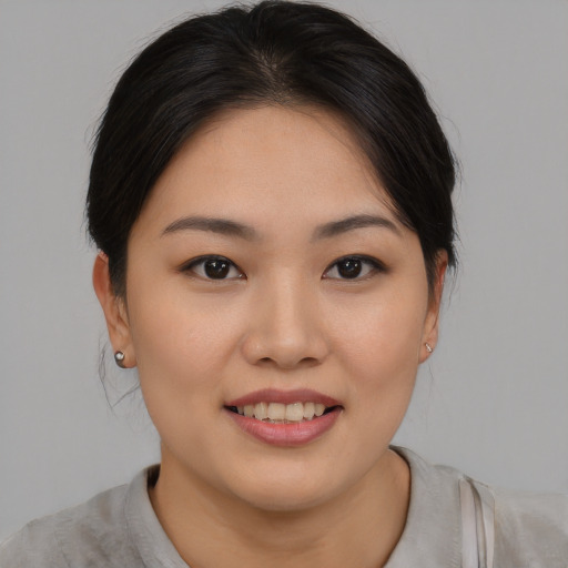 Joyful asian young-adult female with medium  brown hair and brown eyes