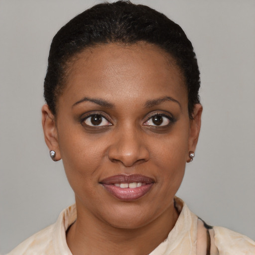 Joyful black young-adult female with short  brown hair and brown eyes