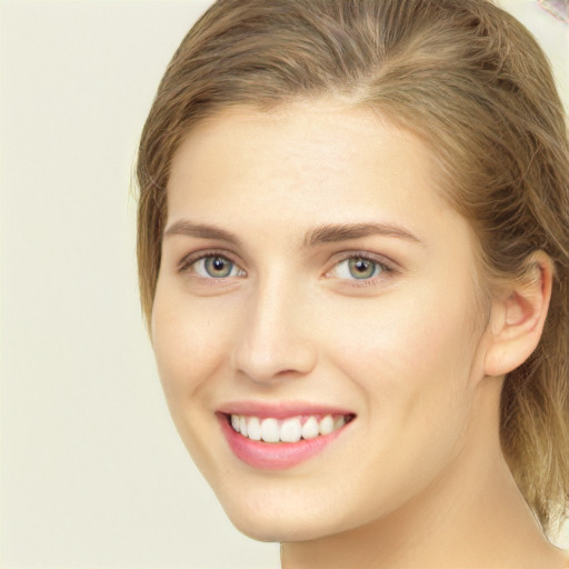 Joyful white young-adult female with medium  brown hair and green eyes