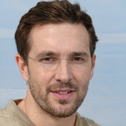 Joyful white adult male with short  brown hair and grey eyes