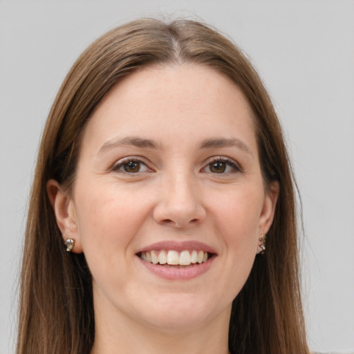 Joyful white young-adult female with long  brown hair and grey eyes