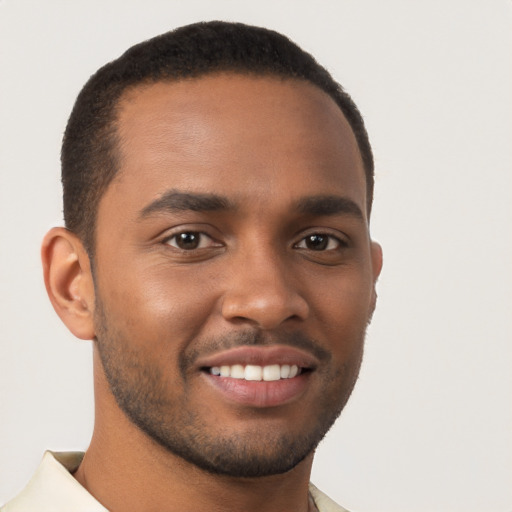 Joyful black young-adult male with short  brown hair and brown eyes