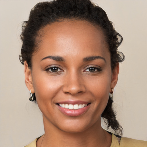 Joyful black young-adult female with short  brown hair and brown eyes