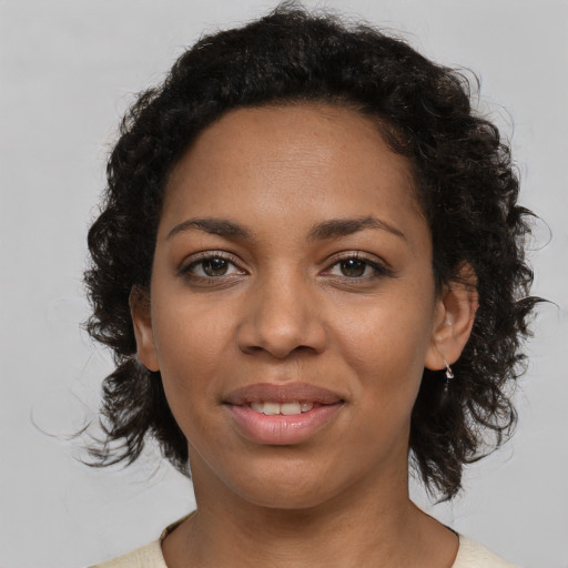 Joyful latino young-adult female with medium  black hair and brown eyes