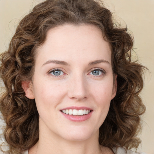 Joyful white young-adult female with medium  brown hair and green eyes