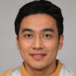 Joyful asian young-adult male with short  black hair and brown eyes